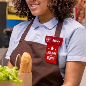 A badge ribbon highlighting the employee of the month attached to a name tag.