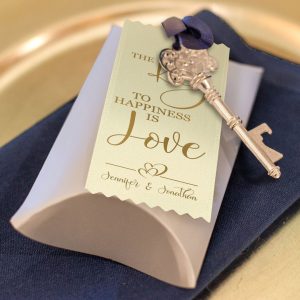 A badge ribbon with a key tied to a wedding party favor.