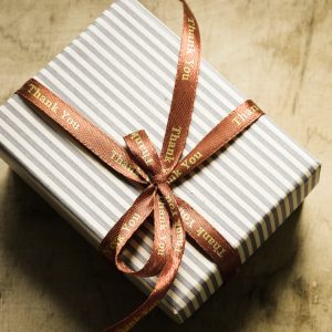 Wrapped gift with a custom imprinted ribbon.