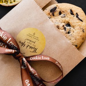 A ribbon roll used to embellish a promotional thank you.