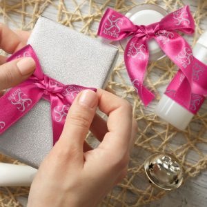 Ribbon rolls tied into bows that are being used as product packaging (one of the key benefits of ribbons).