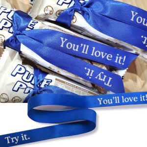 Sample protein bars tied with a promotional ribbon. 